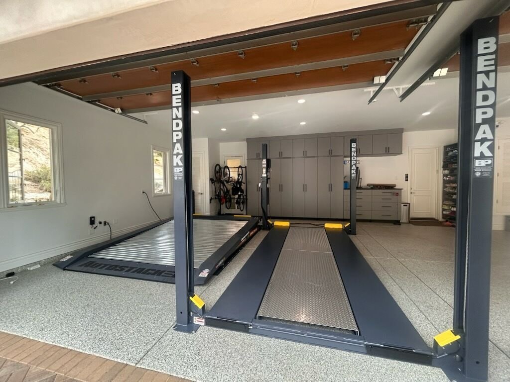 Four-post lift installation in residential garage