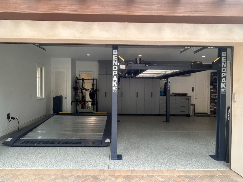 Four-post lift in raised position, residential installation
